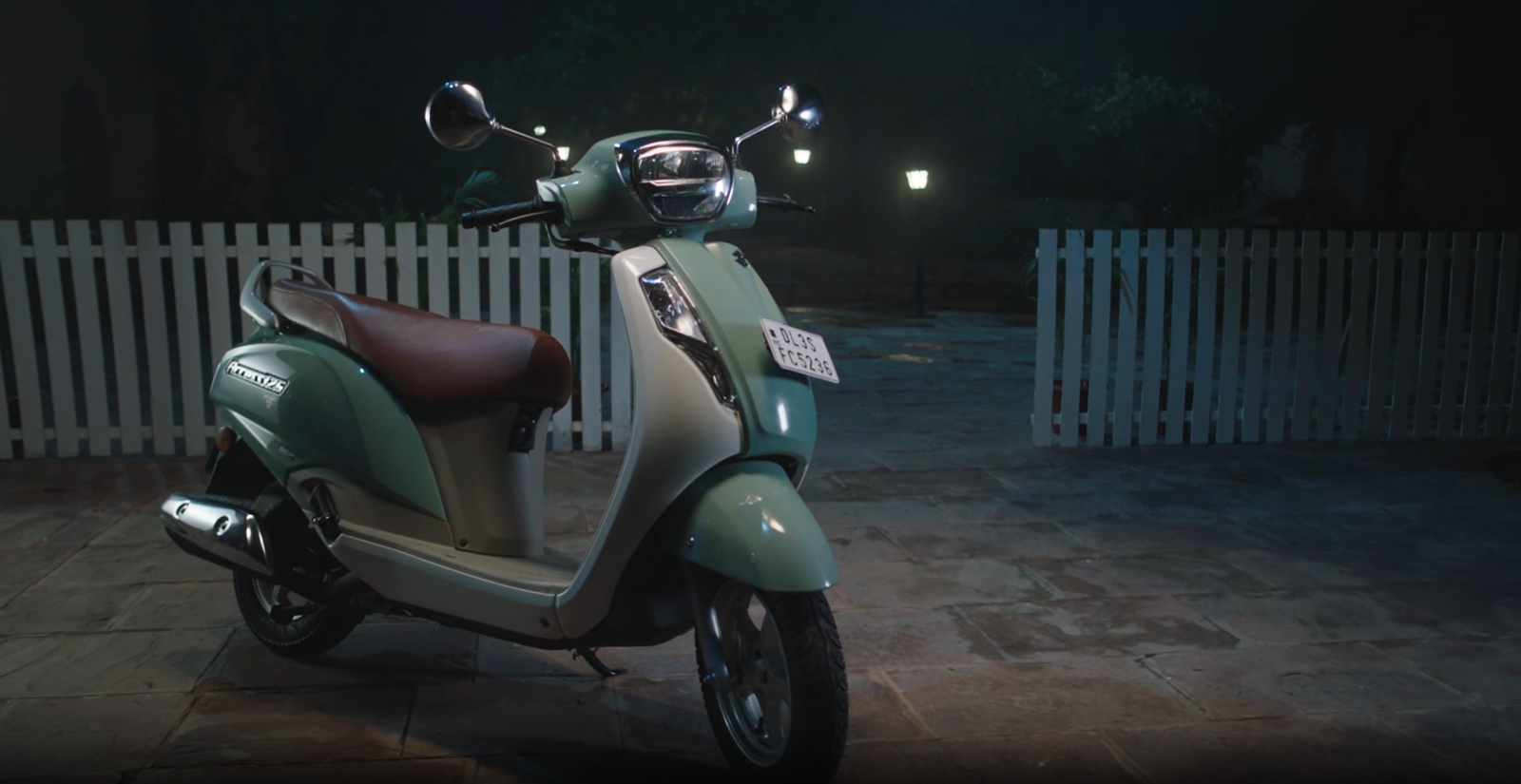 Suzuki TVC — scooter parked in a courtyard at night, film still